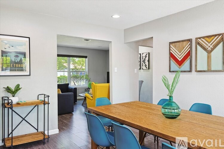 A dining room with a wooden table and blue chairs.
