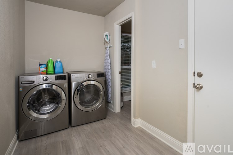 A laundry room with two front loading washing machines.