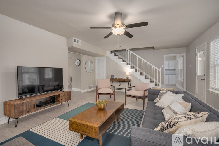 A living room with a television, a couch, and a coffee table.