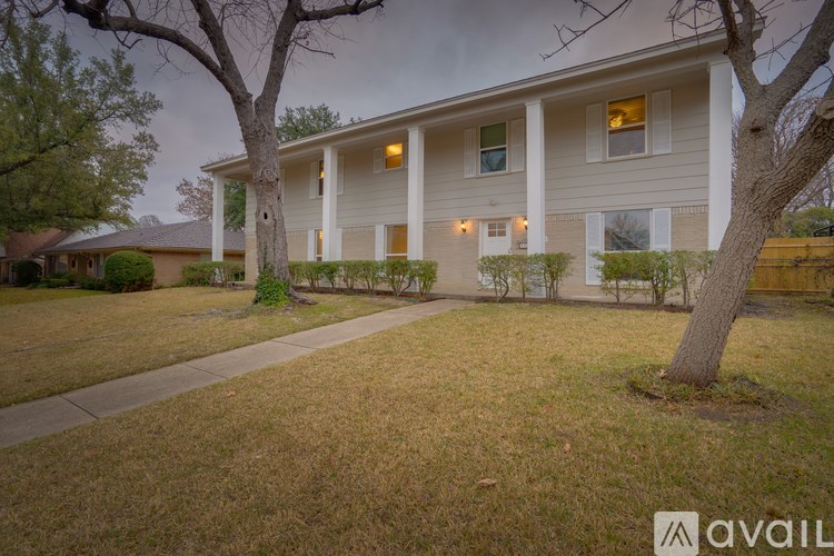 A house with a tree in front of it.