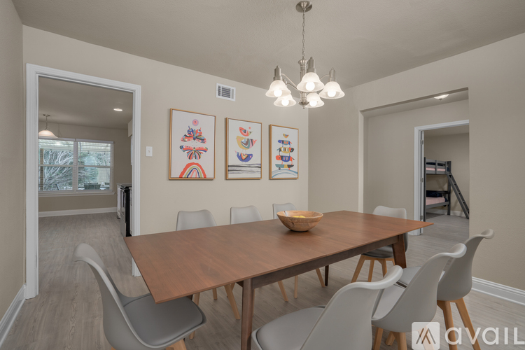 A dining room with a wooden table and chairs.
