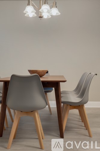 A grey chair sits in front of a wooden table.