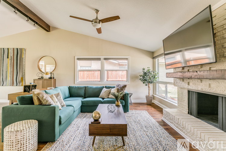 A living room with a green couch and a wooden coffee table.