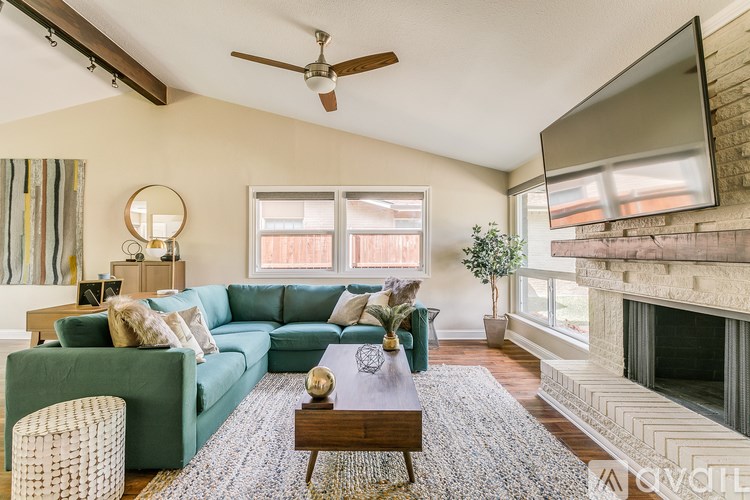 A living room with a green couch and a wooden coffee table.