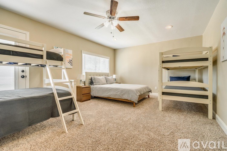 A bedroom with two bunk beds and a single bed.