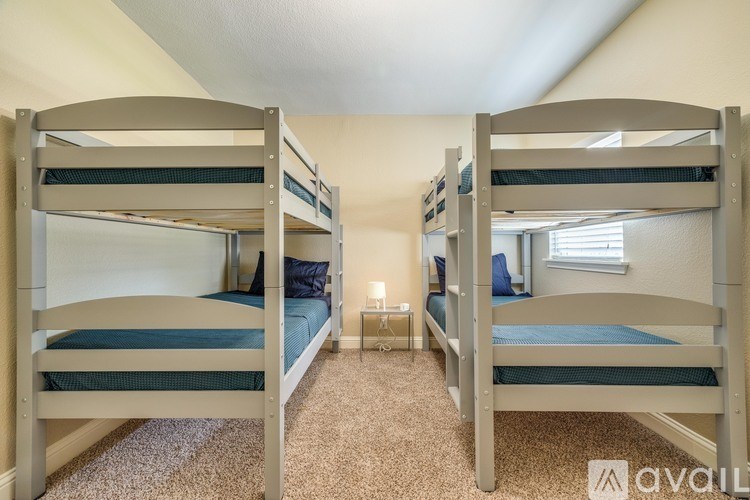 A room with bunk beds and a carpeted floor.