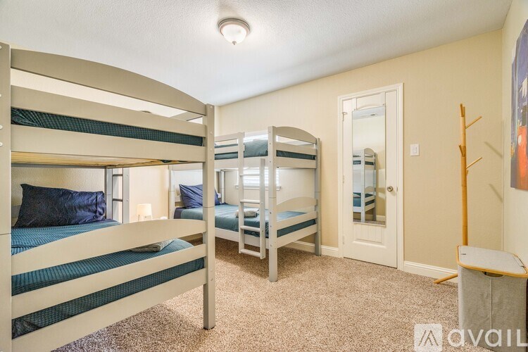 A room with bunk beds and a carpeted floor.