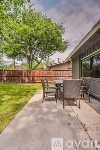 A patio with a table and chairs is shown.