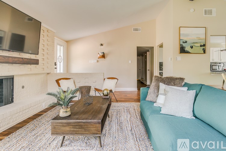 A living room with a blue couch and a wooden coffee table.