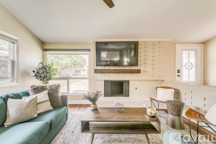 A living room with a green couch and a wooden coffee table.