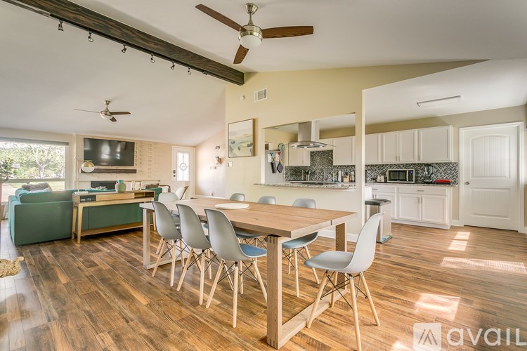 A dining room with a wooden table and chairs.