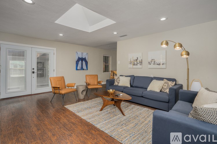 A living room with a blue couch and a coffee table.