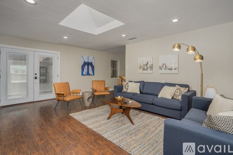A living room with a blue couch and a coffee table.