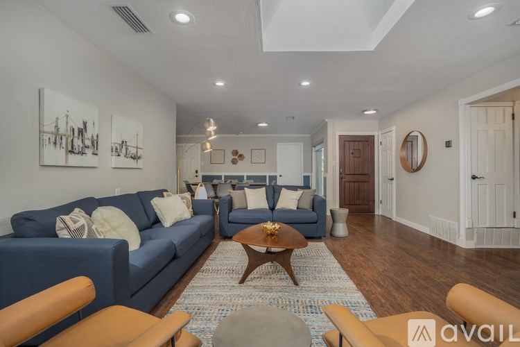 A living room with a blue couch and a coffee table.