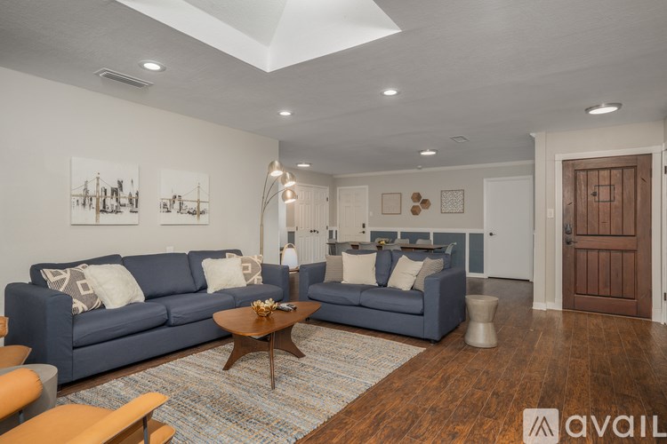 A living room with a blue couch and a coffee table.