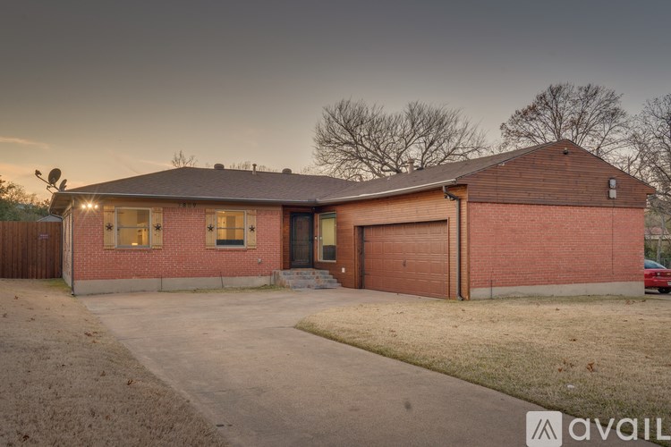 A house with a garage and a driveway is available for sale.