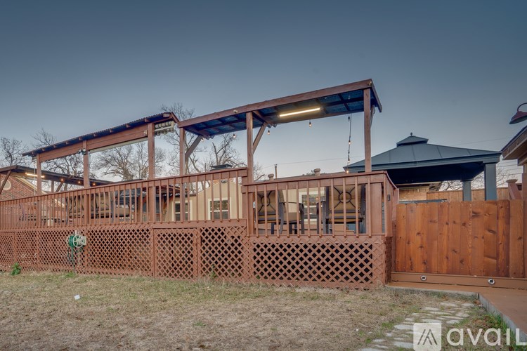 A house under construction with a wooden fence in front.