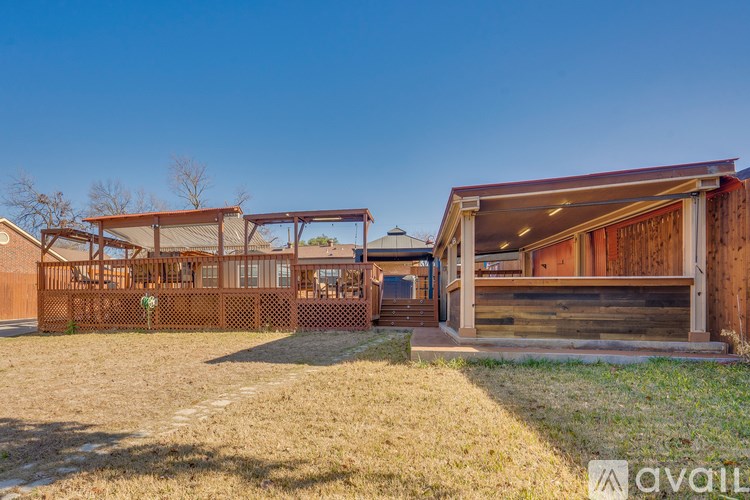 A house with a brown fence and a covered patio area.