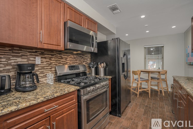 A kitchen with wooden cabinets and a granite countertop.