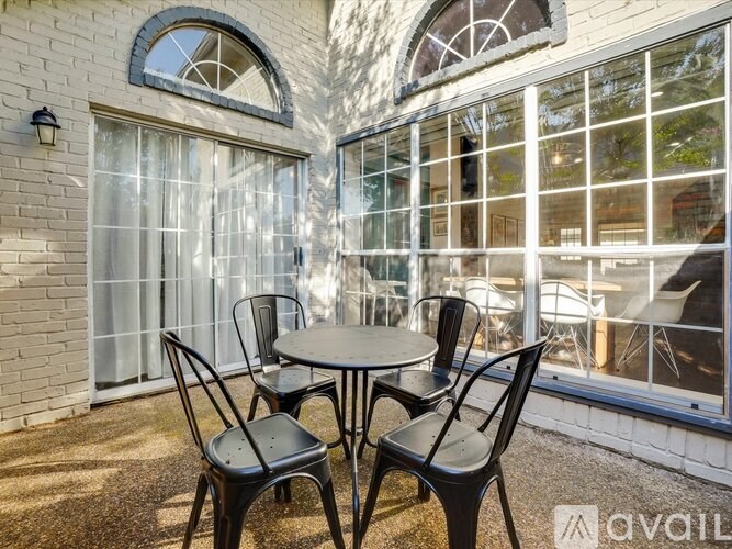 A patio with a table and chairs is set up outside a building.