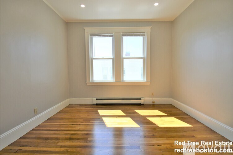 A room with wooden floors and a window.