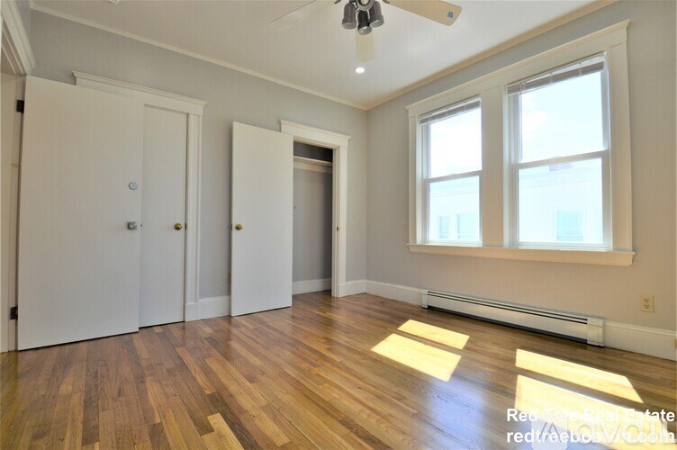 A room with wooden floors and white walls.