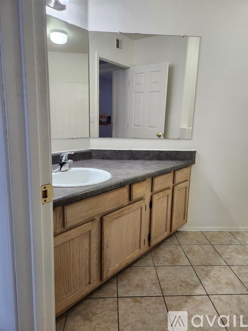 A bathroom with a sink and a mirror.