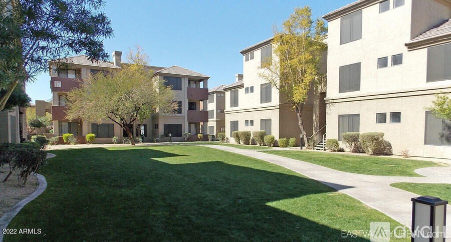 A grassy area in front of apartment buildings.