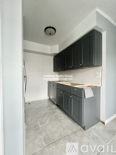 A kitchen with Landstar Realty Group written on the wall.