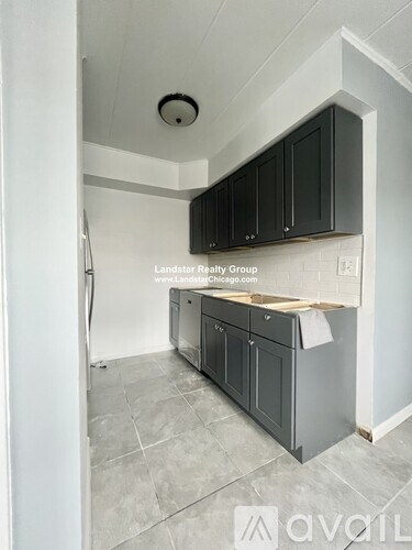 A kitchen with Landstar Realty Group written on the wall.