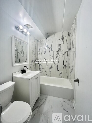 A bathroom with a marble patterned shower and a white toilet.