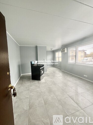 A room with a tiled floor and a brown door.