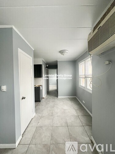 A long hallway with tile floors and white walls.