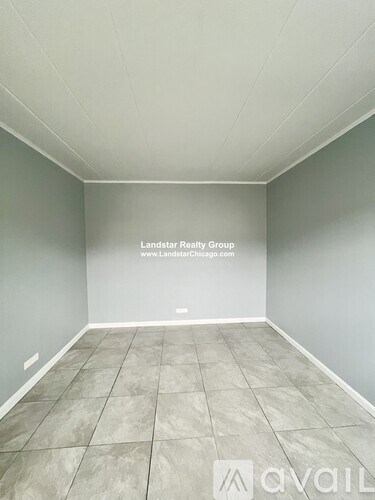 An empty room with a website address for Landstar Realty Group.