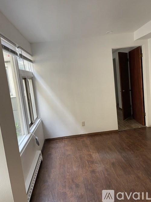 A room with a window and a door.