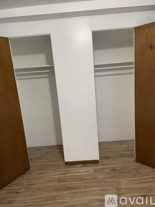 A white shelf stands between two wooden panels.