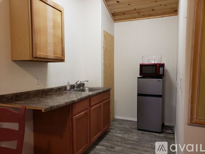 A kitchen with a counter and a fridge.