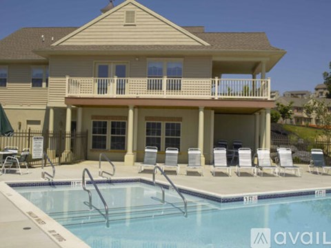 A large house with a pool in front.