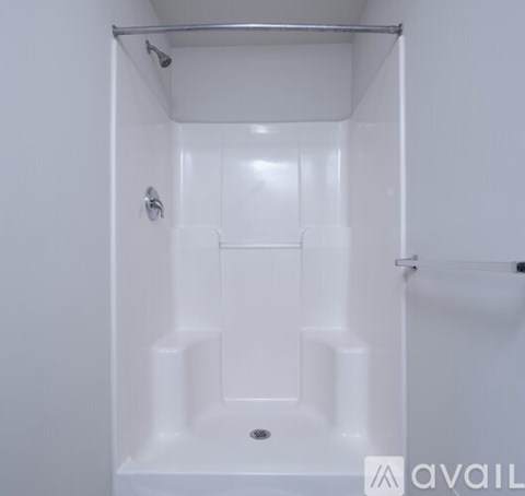 A white bathroom with a shower stall.