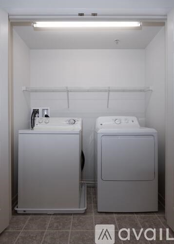 A small bathroom with a washer and dryer.