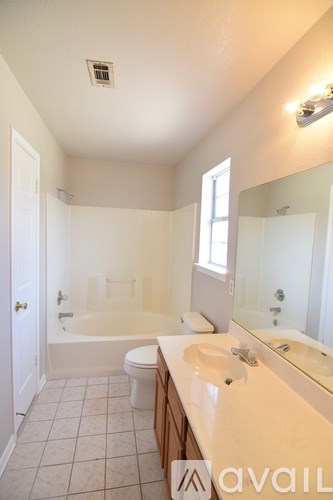 A bathroom with a toilet, sink, and bathtub.