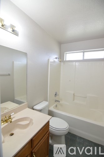 A bathroom with a toilet, sink, and bathtub.