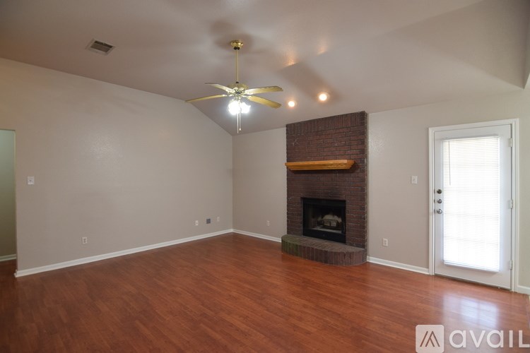 A room with a fireplace and a ceiling fan.