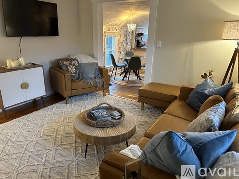 A living room with a brown leather couch and a coffee table.