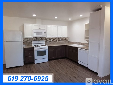 A kitchen with white appliances and cabinets is on the market.