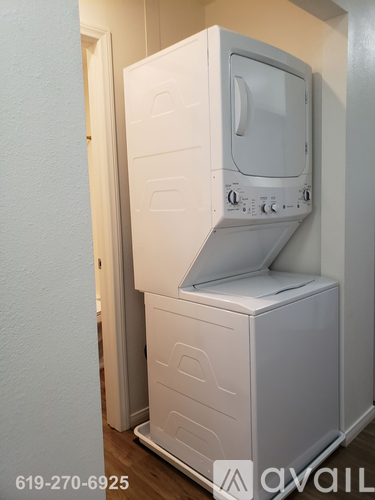 A white microwave oven is on top of a white dishwasher.