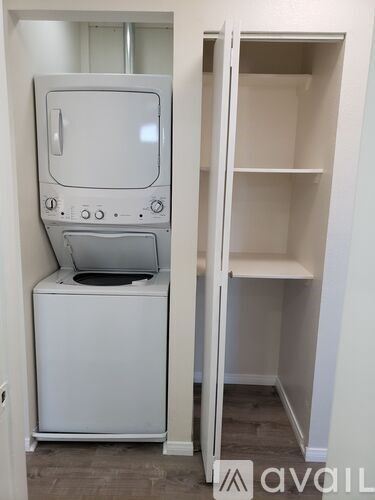 A white microwave oven is on top of a white dishwasher.
