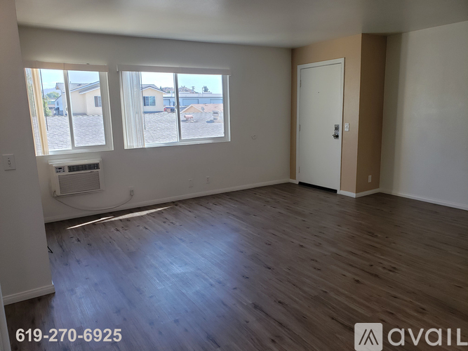 A kitchen with white cabinets and a countertop with a microwave and oven.