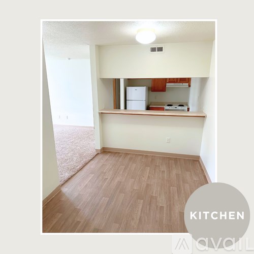 A kitchen area with a refrigerator and a microwave.