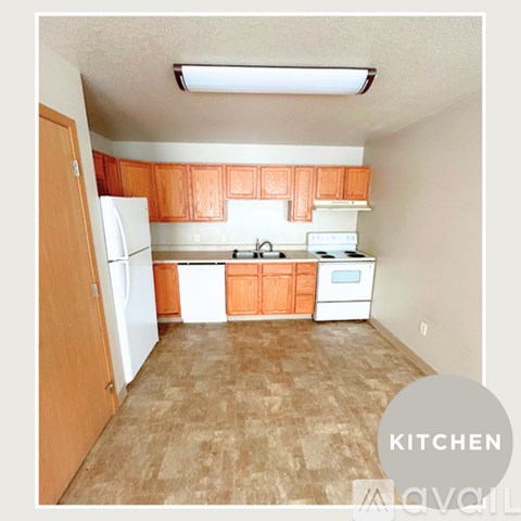 A kitchen with wooden cabinets and white appliances.